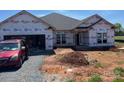 New construction home featuring a two-car garage, well-lit windows, and a modern roof design at 1035 Gardenia Dr # 51, Mt Ulla, NC 28125