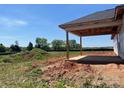 An open, covered patio featuring wooden supports and a concrete floor at 1035 Gardenia Dr # 51, Mt Ulla, NC 28125