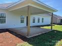A partially covered patio extends from the rear of the house, ideal for outdoor dining and relaxing at 1050 Gardenia Dr # 3, Mt Ulla, NC 28125