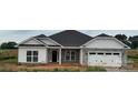 Charming single-story home with stone accents, a two-car garage, and well-manicured lawn at 1050 Gardenia Dr # 3, Mt Ulla, NC 28125