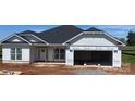 Charming one-story home featuring a two-car garage, white siding, and a dark shingled roof ready for its new owners at 1050 Gardenia Dr # 3, Mt Ulla, NC 28125