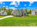 Landscaped home featuring lush greenery and a spacious driveway at 108 Castleview Ln, Mooresville, NC 28115