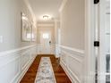 Elegant foyer with hardwood floors, wainscoting, and neutral paint, creating a welcoming entrance at 124 Rosebay Dr, Mooresville, NC 28117