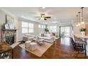 Open-concept living room featuring a fireplace, hardwood floors, and abundant natural light at 124 Rosebay Dr, Mooresville, NC 28117