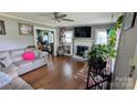 Cozy living room with a fireplace, hardwood floors, and plenty of natural light at 1306 Brantley Rd, Kannapolis, NC 28083