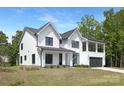 Stunning two-story home with a modern farmhouse design, black trim windows, and a lush front lawn at 13453 Portside Ln, Lancaster, SC 29720
