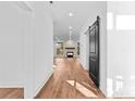 Bright living room with wood floors, a fireplace, and large windows allowing ample natural light at 13453 Portside Ln, Lancaster, SC 29720