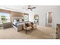This bedroom boasts a tray ceiling, a neutral color scheme, and natural light at 13748 Roderick Dr # 174, Huntersville, NC 28078
