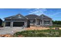 New construction single-story home featuring a stone facade, attached two-car garage, and craftsman-style details at 1469 Mocksville Hwy # 21, Statesville, NC 28625