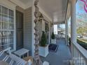 Welcoming front porch featuring a porch swing, rope accent, and potted greenery at 15323 Barnsbury Dr, Huntersville, NC 28078