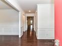 Elegant entryway with gleaming hardwood floors, detailed wainscoting, and a bright, welcoming atmosphere at 15747 Reynolds Dr, Indian Land, SC 29707