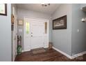 Inviting entryway featuring wood floors, neutral walls, and a stylish front door with decorative glass accents at 1730 Deer St, Charlotte, NC 28214