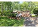 Beautiful home with brick exterior, a well-kept lawn, and surrounded by mature trees, offering a serene setting at 1730 Deer St, Charlotte, NC 28214