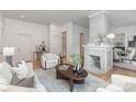 Bright living room showcasing hardwood floors, a modern fireplace, and opening to a dining area at 1824 Umstead St, Charlotte, NC 28205
