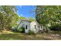 This home features white siding, mature trees, and a well-maintained lawn, creating a serene setting at 2118 Polkville Rd, Shelby, NC 28150