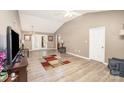 Spacious living room with stylish flooring, leading to a dining area with French doors at 215 Raleigh Nw St, Concord, NC 28027