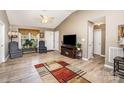 Open-concept living area with wood-look flooring, seating, and ample natural light at 215 Raleigh Nw St, Concord, NC 28027