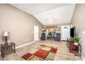 Bright living room with vaulted ceiling, ceiling fan, and wood-look floors at 215 Raleigh Nw St, Concord, NC 28027