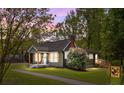 Charming craftsman home with inviting front porch, natural wood accents, and lush landscaping at 2222 Moose Rd, Kannapolis, NC 28083