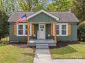 Inviting front porch with American flag, natural wood accents, and 'Welcome' sign at 2222 Moose Rd, Kannapolis, NC 28083