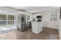 Well-lit kitchen with stainless steel fridge, ample counter space, and an adjacent deck at 2403 Mary Ave, Gastonia, NC 28052
