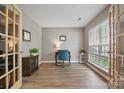 Bright office space with wood-look floors, neutral paint, French doors, and a large window at 2856 Huckleberry Hill Dr, Fort Mill, SC 29715