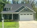Inviting home with a two-car garage, cozy front porch, and lovely landscaping that enhances curb appeal at 3128 Harmon Homestead Rd, Shelby, NC 28150