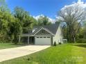 Beautiful home showcasing a spacious driveway, lush lawn, and appealing exterior with a well-maintained yard at 3128 Harmon Homestead Rd, Shelby, NC 28150