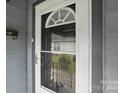 Close-up of front door with decorative window and view of the front yard at 313 Mayflower Ave, Cramerton, NC 28032