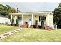 Attractive home with a welcoming front porch, featuring a lovely brick walkway and garden details at 45 Oak St, Great Falls, SC 29055