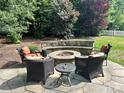 Backyard fire pit area with stone seating, ideal for outdoor gatherings at 4711 Pearmain Dr, Waxhaw, NC 28173