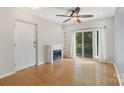Inviting living area with fireplace, ceiling fan, hardwood floors, and access to the balcony at 534 Donatello Ave, Charlotte, NC 28205