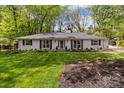 Inviting exterior view of a white brick home with black shutters and a lush green lawn at 641 Charter Pl, Charlotte, NC 28211