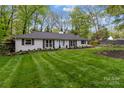 Attractive exterior of a single-story home with a manicured lawn and garden beds at 641 Charter Pl, Charlotte, NC 28211