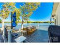 Inviting outdoor dining area on a spacious deck with beautiful lake views at 6788 Bucleigh Rd, Clover, SC 29710