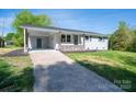 Charming one-story home with attached carport and neutral paint, inviting curb appeal and a concrete driveway at 692 S Pink St, Cherryville, NC 28021