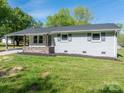 Charming one-story home with fresh, neutral paint, inviting curb appeal and a neatly maintained lawn at 692 S Pink St, Cherryville, NC 28021