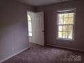 Comfortable bedroom with soft carpet, bright windows, and ample natural light at 7731 Harrington Woods Rd # 17, Charlotte, NC 28269