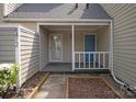 Charming covered front porch with white railing and blue door at 8412 Cricket Lake Dr, Charlotte, NC 28277