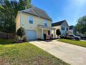 Attractive two-story house with a well-kept lawn and a concrete driveway at 8829 Michaw Ct, Charlotte, NC 28269