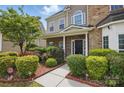 Charming entryway with a beautiful garden featuring vibrant flowers and lush greenery at 8923 Happiness Rd, Harrisburg, NC 28075