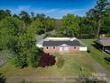 Aerial view of a brick home with a fenced yard, surrounded by lush greenery at 1005 Clarkson St, Rock Hill, SC 29730