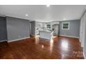 Open-concept kitchen features white cabinets, stainless steel appliances, and hardwood floors at 1005 Clarkson St, Rock Hill, SC 29730