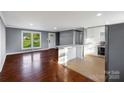 Inviting living room and kitchen area features hardwood floors, island, and stainless appliances at 1005 Clarkson St, Rock Hill, SC 29730