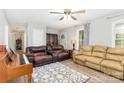 Inviting living room featuring comfortable seating, neutral walls, a ceiling fan, and a decorative rug at 103 Woodwinds St, Locust, NC 28097