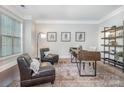 Inviting home office with a large window and comfortable seating area at 10328 Lemington Dr, Mint Hill, NC 28227
