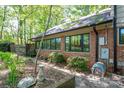Brick home's exterior showcasing a brick wall, garden bed, and walkway leading to a charming backyard space at 1058 General Hoke Dr, Lincolnton, NC 28092