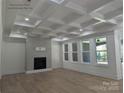 Spacious living room with coffered ceilings, fireplace, and plenty of natural light at 110 Hunts Landing Dr, Mooresville, NC 28117