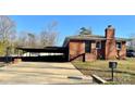 Charming single-story brick home with a covered carport and well-maintained front lawn at 1148 Marietta St, Charlotte, NC 28214
