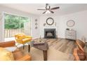 Living room showcasing a fireplace, modern furniture and a view to the outdoor deck at 1203 Maple Shade Ln, Charlotte, NC 28270